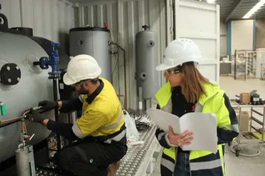 Instructor reviewing the training manual with a trainee