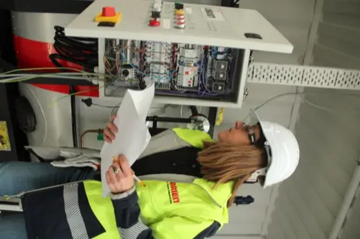 Trainee inspecting an O'Brien boiler control panel